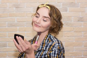 girl doing makeup with brush