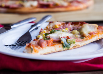 pizza with sausage, chicken, corn and cheese