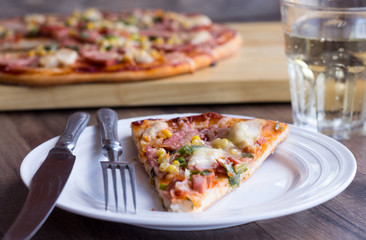 pizza with sausage, chicken, corn and cheese