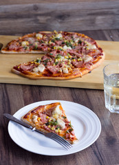 pizza with sausage, chicken, corn and cheese