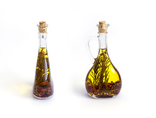Two bottles with olive oil and herbs