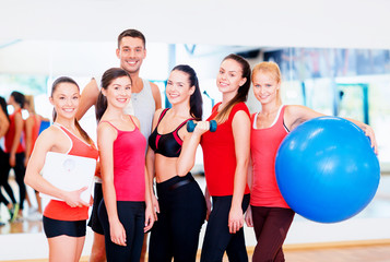 group of smiling people in the gym