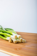 green onion on wooden board