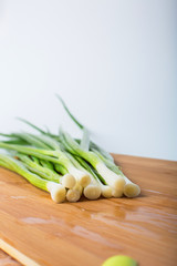 green onion on wooden board