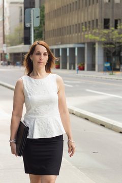 Business woman walking on a downtown sidewalk