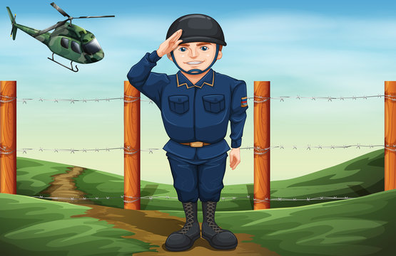 A soldier in front of the barbwire fence