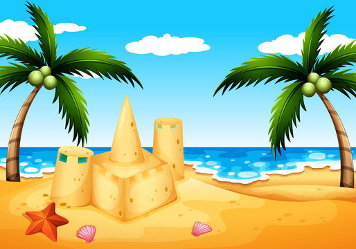 A beach with coconut trees and a sand castle