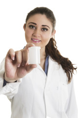 Young beautiful female doctor holding a pill bottle