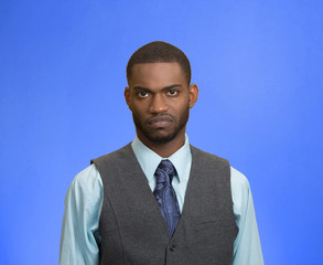 Grumpy, skeptical, displeased man isolated on blue background