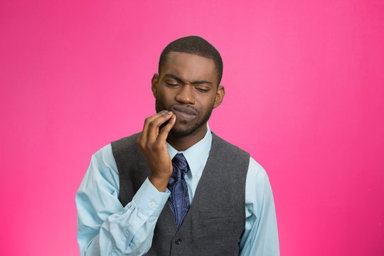 Man with tooth ache, pain isolated on pink background 