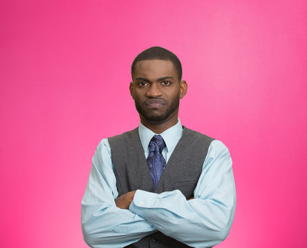 Grumpy, skeptical, displeased man isolated pink background 