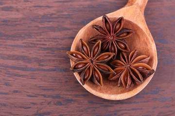 Spoon with beautiful anise, on wooden table