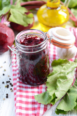 Fototapeta na wymiar Grated beetroots in jar on table close-up