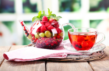 Fruit red tea with wild berries in glass cup,