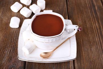 Cup of hot chocolate on table, close up