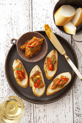 close up french bread and spicy beef sauce on black dish