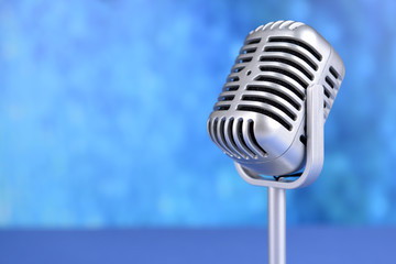 Vintage microphone on blue background