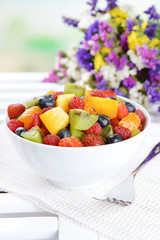 Delicious fruits salad in plate on table close-up