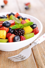 Delicious fruits salad in plate on table close-up