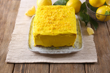 Tasty lemon cake on wooden table