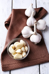 Fresh sliced garlic on wooden background