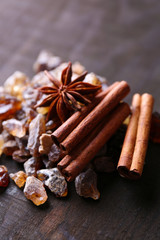 Reed sugar and spices on wooden background