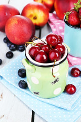 Sweet berries in cup on table close-up