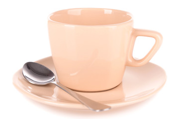 Empty cup with tea spoon isolated on white