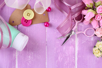 Scrapbooking craft materials on color wooden background