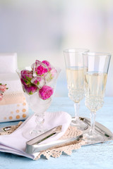 Ice cubes with rose flowers in glass bowl and two glasses with