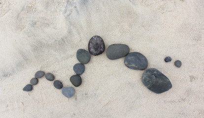 Fototapeta na wymiar Pebble Design on Sand 2