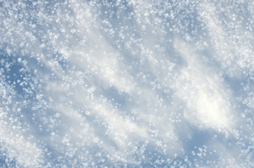 Falling snowflakes on  blue background