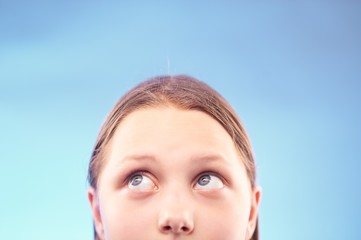 Teen girl looking up