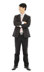 smiling businessman standing and crossed arms