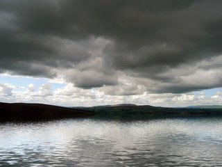 Obraz na płótnie Canvas Moody clouds over water