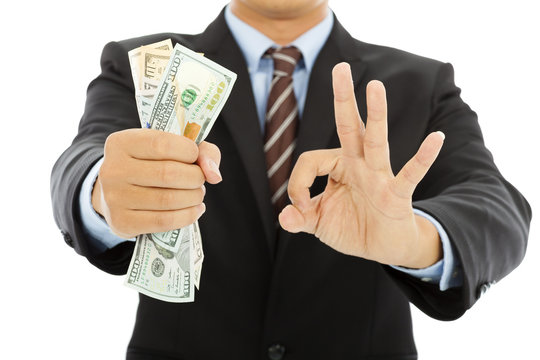 businessman grasp us dollars with ok gesture
