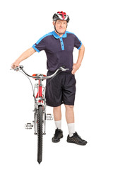 Healthy mature man pushing a bike