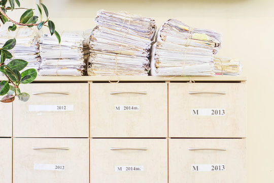 Filing Cabinet And A Stack Of Old Papers Tied With A Rope