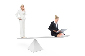 White scales measuring two businesswomen
