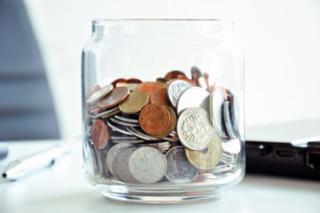 Coins in the glass jar - multi Asian currencies - saving concept