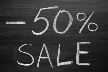 50-percent sale title written with a chalk on the blackboard