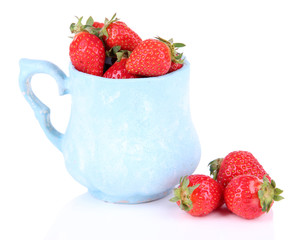 Ripe sweet strawberries in color mug isolated on white