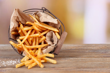Tasty french fries in metal basket