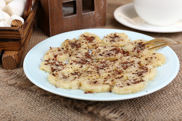 Sweetened fried banana on plate, close-up