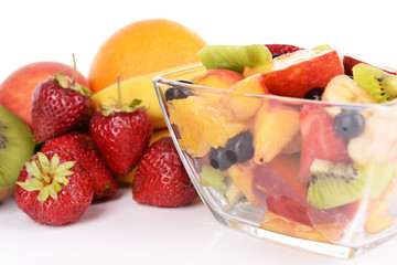 Fresh fruits salad in bowl with fruits and berries close up