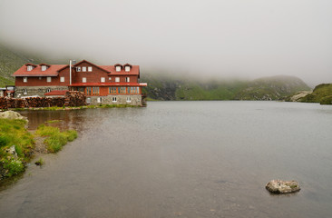 Fototapeta premium mountain hut and lake