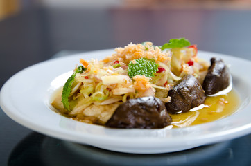 Spicy mushroom salad in white plate