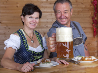 Fototapeta na wymiar Man and woman in bavarian costume at the snack