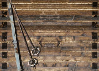 Foto op Plexiglas Historic blue ski with poles on wooden wall © mezzotint_fotolia