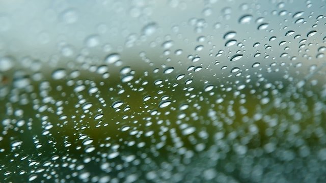 Raindrops on a car window,  windshield with wipers